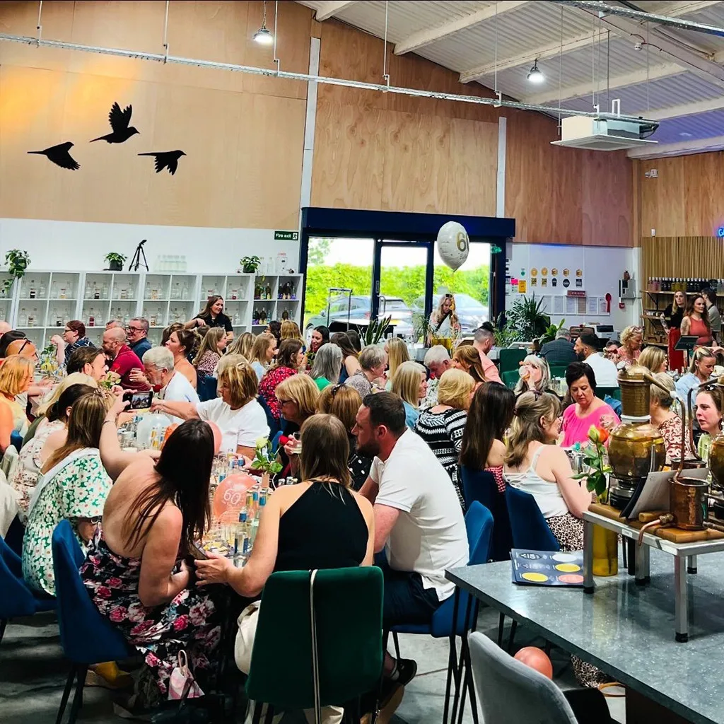 large crowd of people celebrating at three wrens gin tasting tour event in 2024