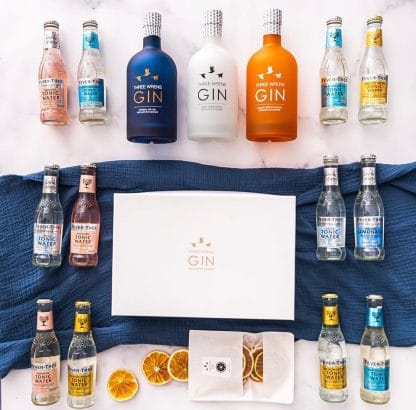 gin staycation gift box bottles garnish pack laid out on flat background