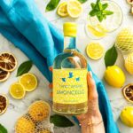 limoncello lemon gin bottle yellow label in hand