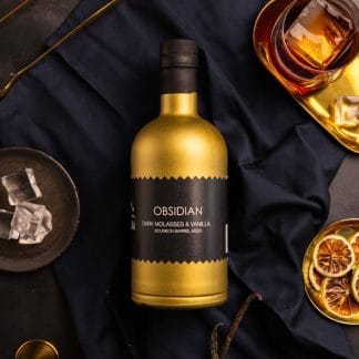 obsidian luxury english craft rum golden bottle black label dark background glass ice